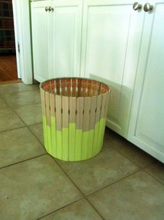 a wooden basket sitting on the floor in a kitchen