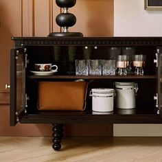 an old fashioned cabinet is filled with glasses and other items