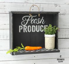 a sign that says fresh produce with carrots and parsley on the shelf next to it