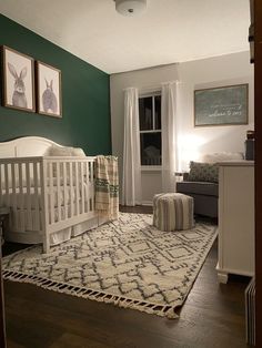 a baby's room with green walls and white crib in the corner,