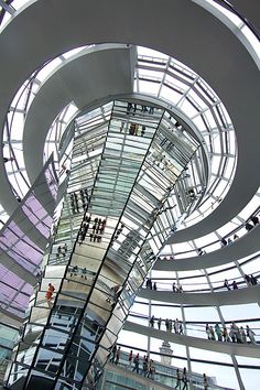 the inside of a building with many people standing in it