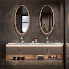 a bathroom with two sinks and mirrors on the wall