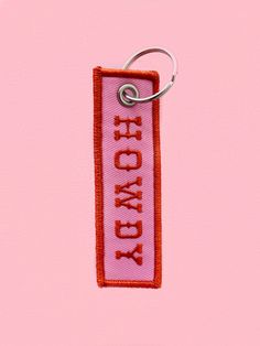 a pink keychain with the words hollywood on it