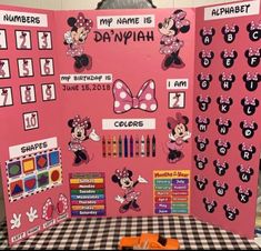 a pink bulletin board with minnie mouses on it