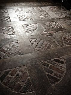 the floor is covered in intricately carved designs and patterns, including letters that are interlocked to each other