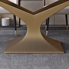 a modern dining table with two chairs in front of it and an area rug on the floor