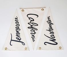 two white pennants with black writing on them