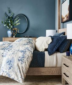 a bedroom with blue walls and wooden furniture