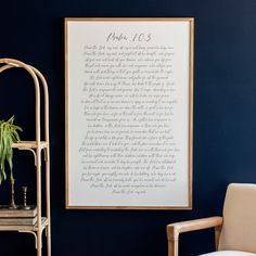 a framed poem on the wall next to a chair with a potted plant in it