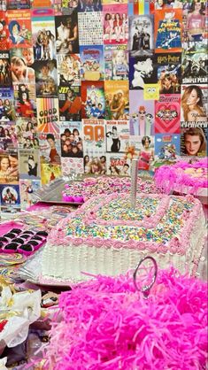 there are many cakes on the table with pink and white frosting, as well as pictures