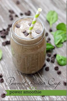 a smoothie in a mason jar with chocolate chips on the side and a green striped straw