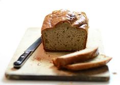 a loaf of bread sitting on top of a cutting board with a knife next to it