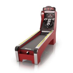 a red arcade bowling machine sitting on top of a white floor next to a remote control