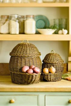 two baskets filled with potatoes sitting on top of a counter