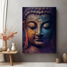 a buddha statue sitting on top of a wooden table next to a vase filled with flowers