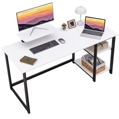 a desk with two laptops on it and a lamp in the corner next to it