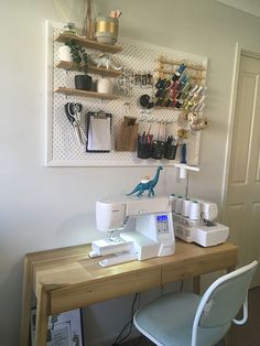 a sewing machine sitting on top of a wooden desk next to a chair and shelf