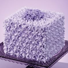 a purple cake with lots of ruffles on it