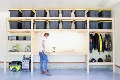 a man standing next to a shelf filled with lots of items