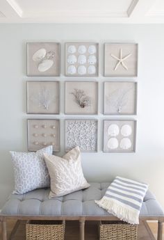 a bench with pillows and pictures on the wall