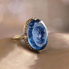 "As soon as this charming ring comes into your possession, you'll notice the details that contribute to its beauty. The intaglio is a reverse cameo with an incised, etched image and is handmade, using the very same process used by Bohemian glass makers of the last centuries. Beloved by Catherine the Great, intaglios were made in glass, agate, even lava -- all treasured for their exquisite detail. We set the intaglio into a delicate, yet sizeable ring design with an open bezel and under-gallery, Diamond Intaglio Jewelry, Round Diamond Intaglio Jewelry, Luxury Sapphire Rings Collectible, Luxury Sapphire Rings For Collectors, Fine Jewelry Diamond Intaglio, Fine Jewelry Diamond With Intaglio Detail, Fine Diamond Intaglio Jewelry, Collectible Fine Jewelry Intaglio Rings, Diamond Intaglio Fine Jewelry Rings