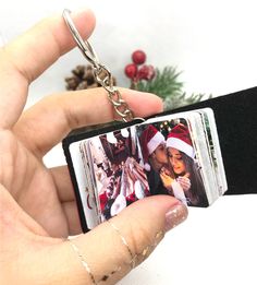 a person holding a cell phone in their hand with a christmas card attached to it