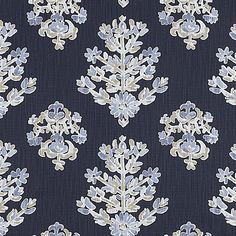 a blue and white wallpaper with small floral designs on it's side,