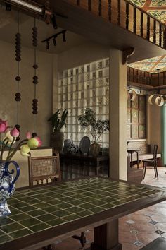 a dining room table with vases on top of it