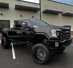 a black truck parked in front of a building