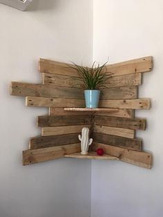 a potted plant sitting on top of a shelf made out of wooden planks