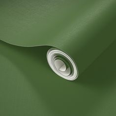 a close up view of a green fabric with a white circle on the center and bottom