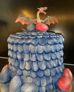 there is a cake made to look like a dragon on top of rocks and balls