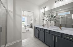 a large bathroom with double sinks and mirrors