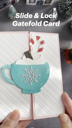 someone is holding up a card with a teacup on it and the words slide & lock gatefold card