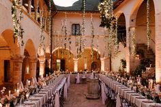 an indoor dining area with tables and chairs set up for a formal function in the evening