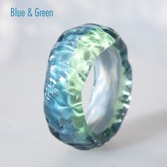 a blue and green ring sitting on top of a table