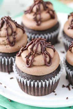 cupcakes with chocolate frosting and sprinkles on a plate