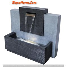 an outdoor fountain with water running from it's sides and lights on the side