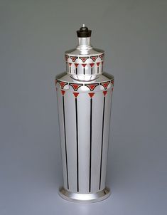 a white and black vase sitting on top of a table