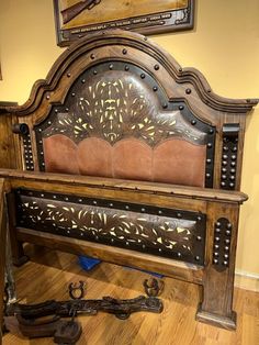 an old wooden bench with ornate carvings on the back and sides, sitting in a room