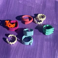 several different types of rings on a purple surface