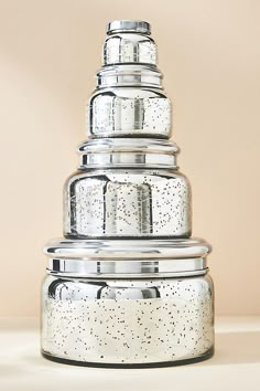 a stack of glass containers sitting on top of a table