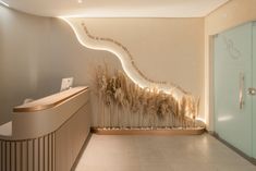 a lobby with a glass door and some plants on the wall