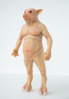 a toy pig standing on its hind legs with one eye open and the other half closed