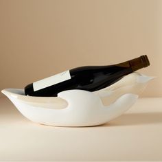 a bottle of wine in a white bowl