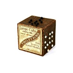 a wooden dice with black and white balls on it