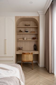 a bedroom with a bed, desk and shelves