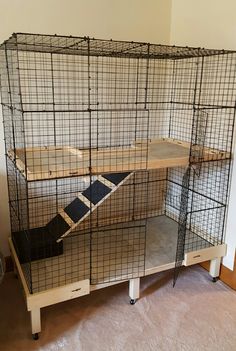 a cage that is sitting on top of a shelf in the middle of a room