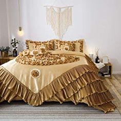 a bed with gold ruffled bedspread and pillows