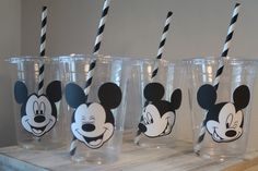 four mickey mouse cups with black and white straws